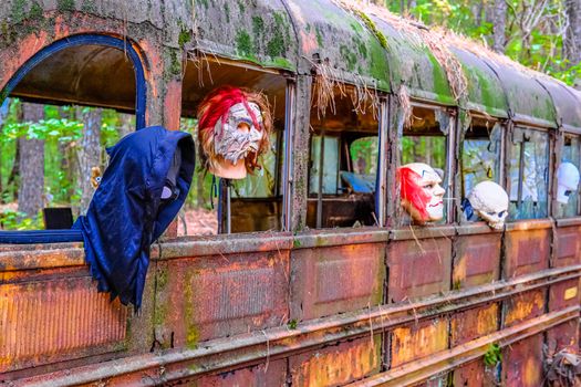 Halloween Masks in a Horror School Bus in a junkyard