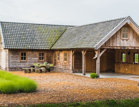 Old rustic and charming wooden house in the middle of a lavender field