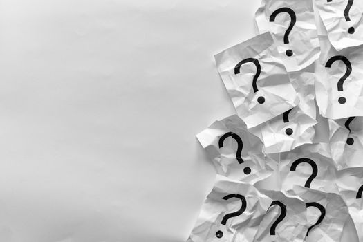Border of crumpled question marks on cards over a white background with copy space in a conceptual image