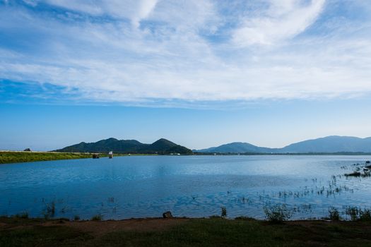 The Sea landscape with boats against the mountains, beautiful white clouds