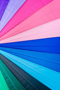 Rainbow spectrum multicolored texture of an umbrella as background.