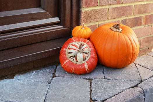 Collection of seasonal gourds as a Thanksgiving decoration with copy space on front door step