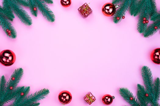 Christmas holidays composition, top view of red Christmas decorations on pink background with copy space for text. Flat lay, winter, postcard template, new year concept.