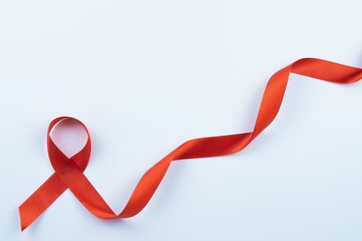 Aids awareness, red ribbon on white background with copy space for text. World Aids Day, Healthcare and medical concept.