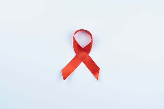 Aids awareness, red ribbon on white background with copy space for text. World Aids Day, Healthcare and medical concept.