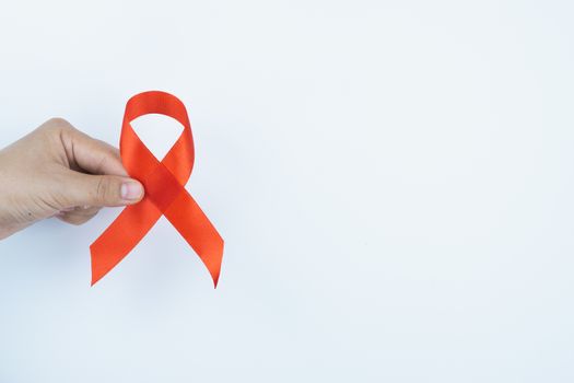 Aids awareness, male hands holding red AIDS awareness ribbon on white background. World Aids Day, Healthcare and medical concept.