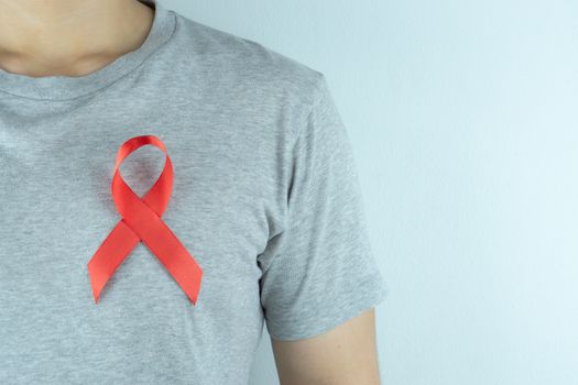 Aids awareness, red ribbon on the man chest. World Aids Day, Healthcare and medical concept.