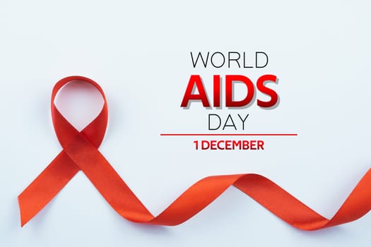 Aids awareness, red ribbon on white background with copy space for text. World Aids Day, Healthcare and medical concept.