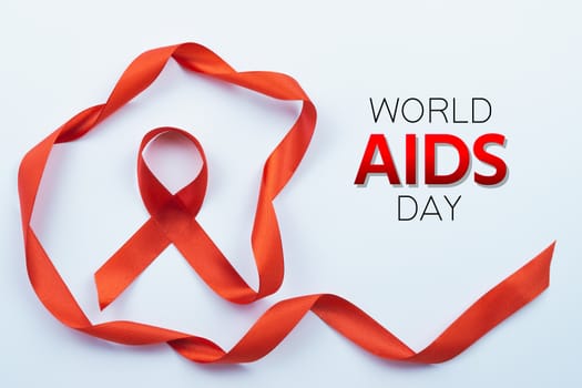 Aids awareness, red ribbon on white background with copy space for text. World Aids Day, Healthcare and medical concept.