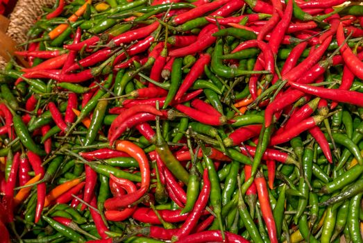 vegetables and condiments made of peppers and multicolored peppers on a stall