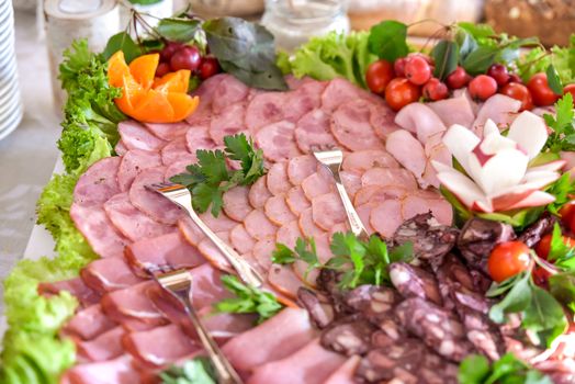 Meat sausage slices assortment on Party Plate at wedding event
