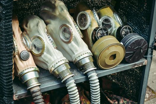 Set of old military gas mask on the shelf.