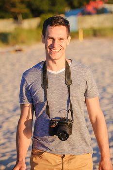 Silhouette of young photographer on the beach. Summer time