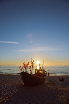 fisherman boats at sunrise time on the beach in summer