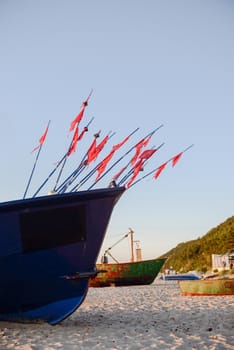 fisherman boats at sunrise time on the beach in summer