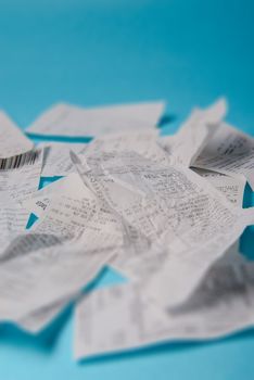 Pile of shopping receipts on a blue background