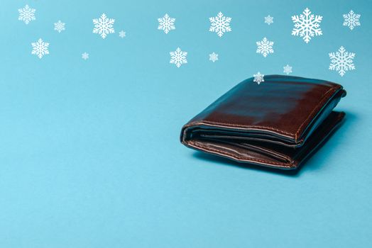 brown mans leather wallet on a blue background