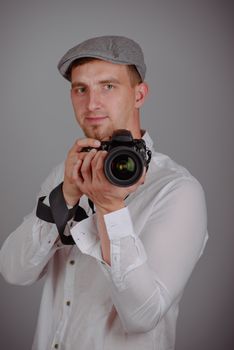 Young man using a professional camera in studio