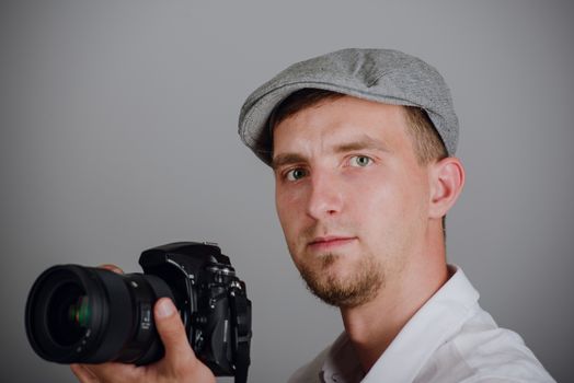 Young man using a professional camera in studio