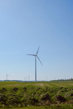 Bright blue sky moving and wind turbine.