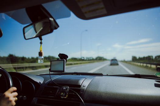 car and blue sky with blurred clouds.