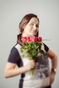 portrait of young charming girl with a bouquet of roses Valentine's Day