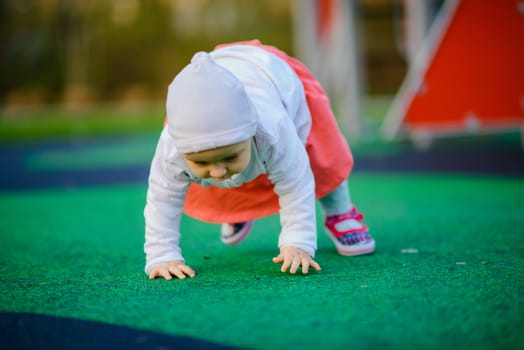 Little girl spending fantastic time on playground. Happy childhood. Authentic image