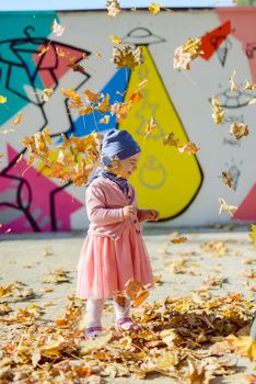 Adorable girl having fun on beautiful autumn day. authentic childhood image