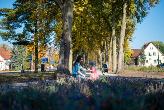 Happy loving family. Father and his daughter child girl playing and hugging outdoors. Cute little girl hugs daddy. Concept of Father's day. Authentic image.