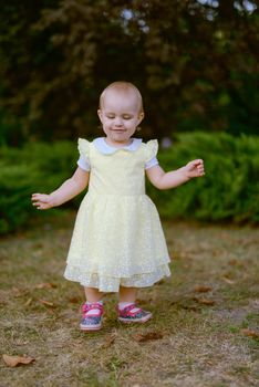 Smiling girl on the meadow looking right at camera. authentic image. Smell roses flowers