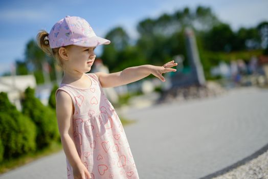 Little girl spending fantastic time on playground. Happy childhood. Authentic image