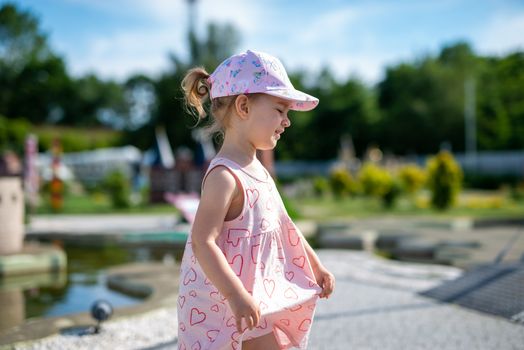 Little girl spending fantastic time on playground. Happy childhood. Authentic image