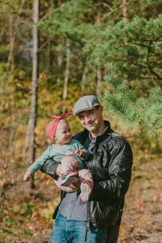 Happy loving family. Father and his daughter child girl playing and hugging outdoors. Cute little girl hugs daddy. Concept of Father's day. Authentic image.