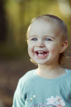 Adorable girl having fun on beautiful autumn day. authentic childhood image