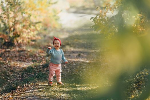 Adorable girl having fun on beautiful autumn day. authentic childhood image