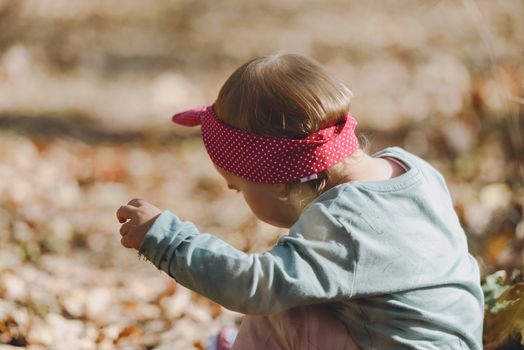 Adorable girl having fun on beautiful autumn day. authentic childhood image