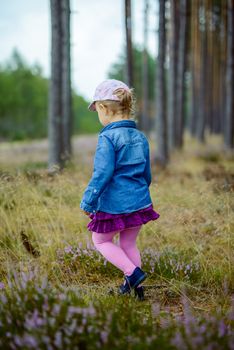 Adorable girl having fun on beautiful autumn day. authentic childhood image