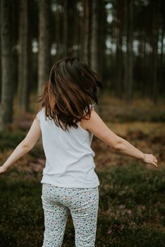 a photo of woman in the forest where the purple heather blooms. copy space. authentic image