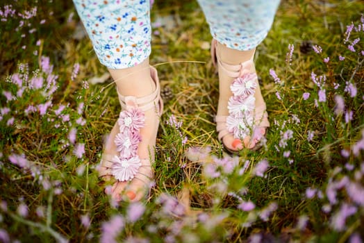 a photo of woman in the forest where the purple heather blooms. copy space. authentic image