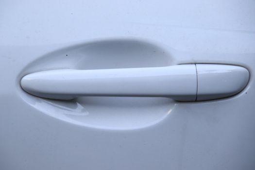 Close up of White car door handle 