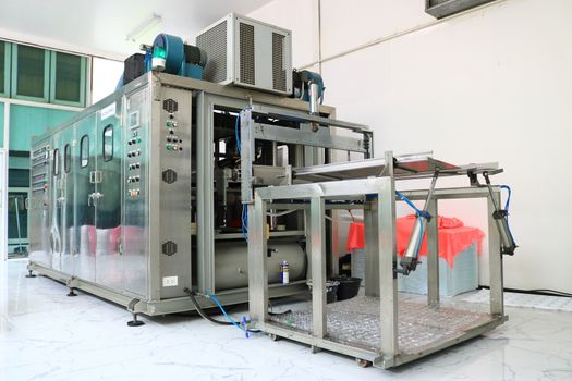 Vacuum thermoforming machine in the factory,Vacuum thermoforming machine is used for producing plastic packaging,Vacuum thermoforming machine in factory room,Photos from the back of the device