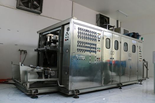 Vacuum thermoforming machine in the factory,Vacuum thermoforming machine is used for producing plastic packaging,Vacuum thermoforming machine in factory room,Photos from the back of the device