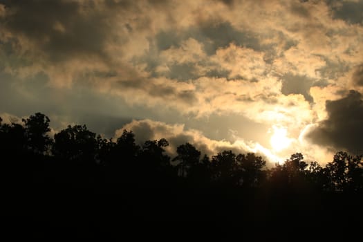 Sunset landscape view of silhouette mountains with sky and clouds and sun,twilight sky and clouds with evening sunset background,Beautiful scene of nature