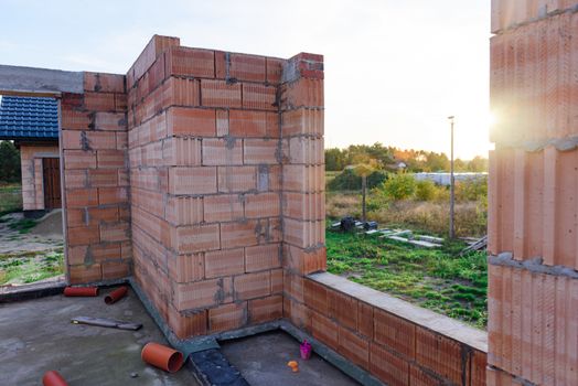 Interior of a Unfinished Red Brick House Walls under Construction without Roofing.