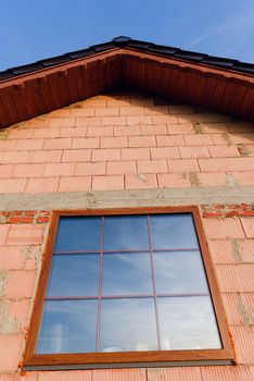 Interior of a Unfinished Red Brick House Walls under Construction without Roofing.