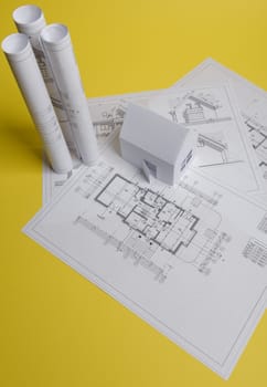 Yellow paper block of flats on yellow background paper. Minimalistic and simple concept, style. Copy space. Horizontal orientation.