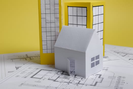 Yellow paper block of flats on yellow background paper. Minimalistic and simple concept, style. Copy space. Horizontal orientation.