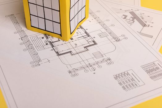Yellow paper block of flats on yellow background paper. Minimalistic and simple concept, style. Copy space. Horizontal orientation.