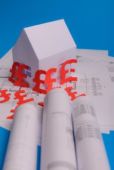 White family paper house , british pound money symbol , house projects plan and blueprints on mint background paper. Minimalistic and simple concept, style. Vertical orientation. View from above. copy space