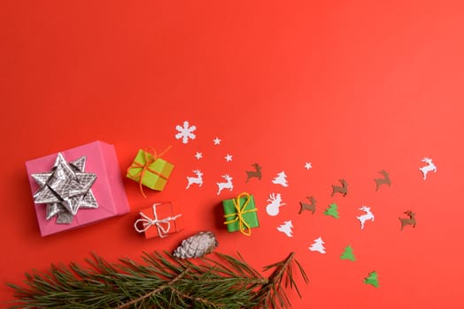 Christmas or New Year background, plain composition made of Xmas decorations and fir branches, flat lay, blank space for a greeting text.